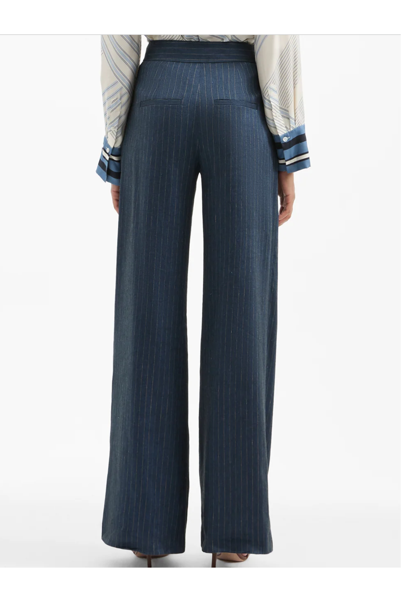Navy pinstripe pants worn by a person on a white background