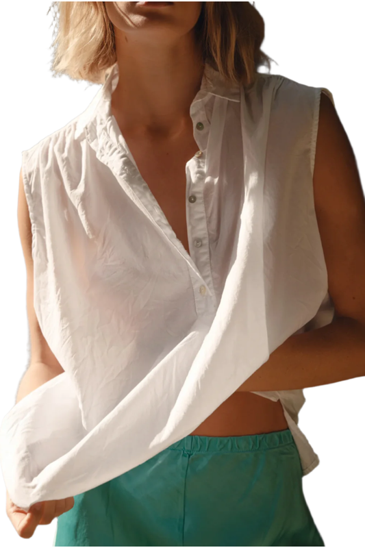 White sleeveless blouse worn by a person on a white background