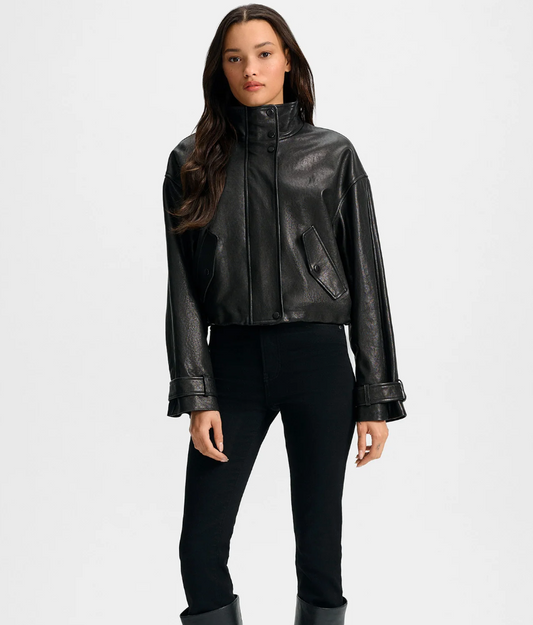 Woman wearing a black leather jacket on a white background
