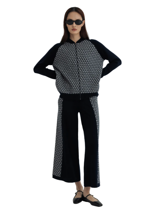 Woman wearing a black and white patterned outfit on a white background