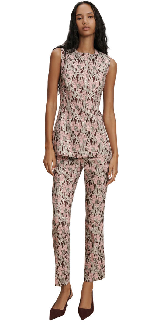 Woman wearing a floral sleeveless top and pants set on a plain background