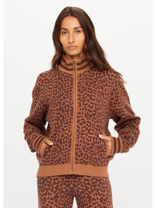 Woman wearing a brown leopard print tracksuit on a white background