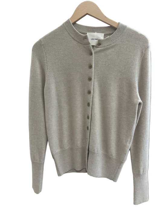Sand Beige sweater on a white surface with a blurred background