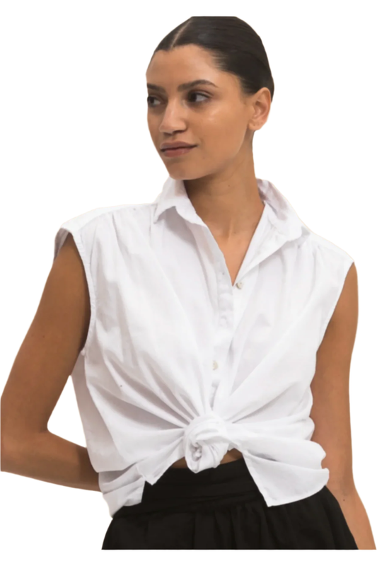 Woman wearing a white sleeveless blouse with a knot detail on a white background