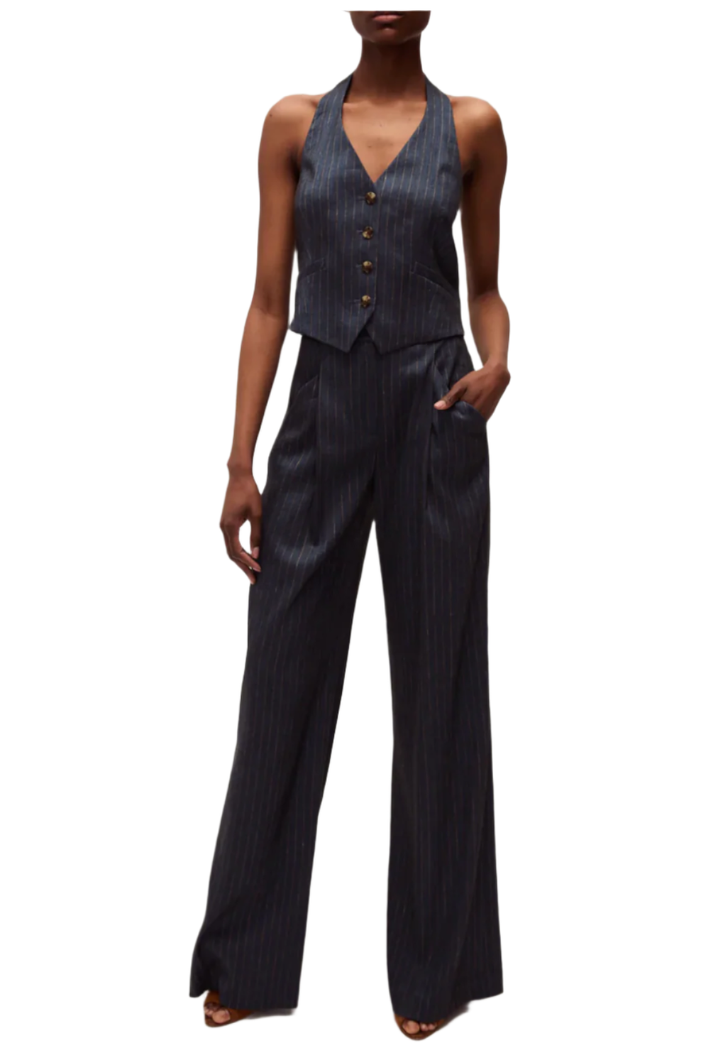 Woman wearing a dark pinstripe suit on a white background
