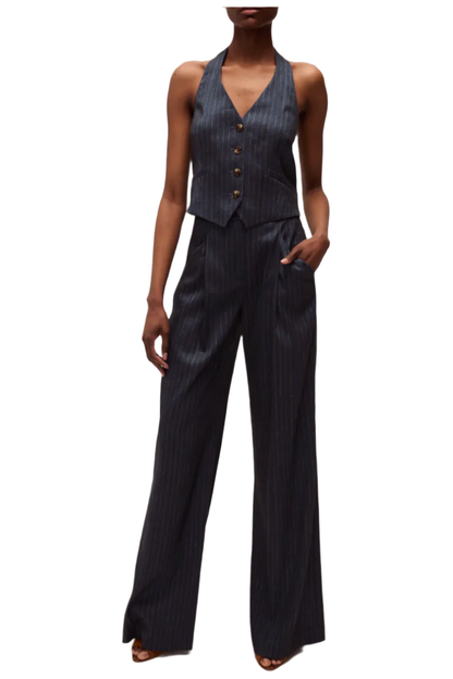 Woman wearing a dark pinstripe suit on a white background