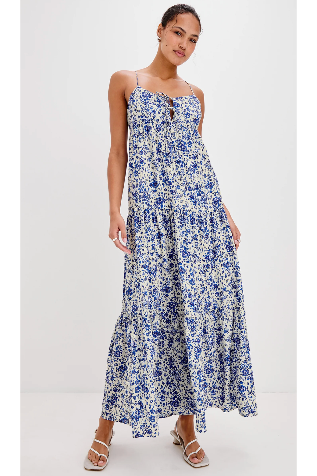 Woman wearing a blue floral dress on a white background