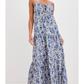 Woman wearing a blue floral dress on a white background