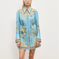 Woman wearing a blue floral dress with a white background