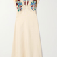 Cream-colored dress with floral lace details on a white background