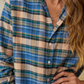 Person wearing a plaid shirt with a focus on the collar and chest area.