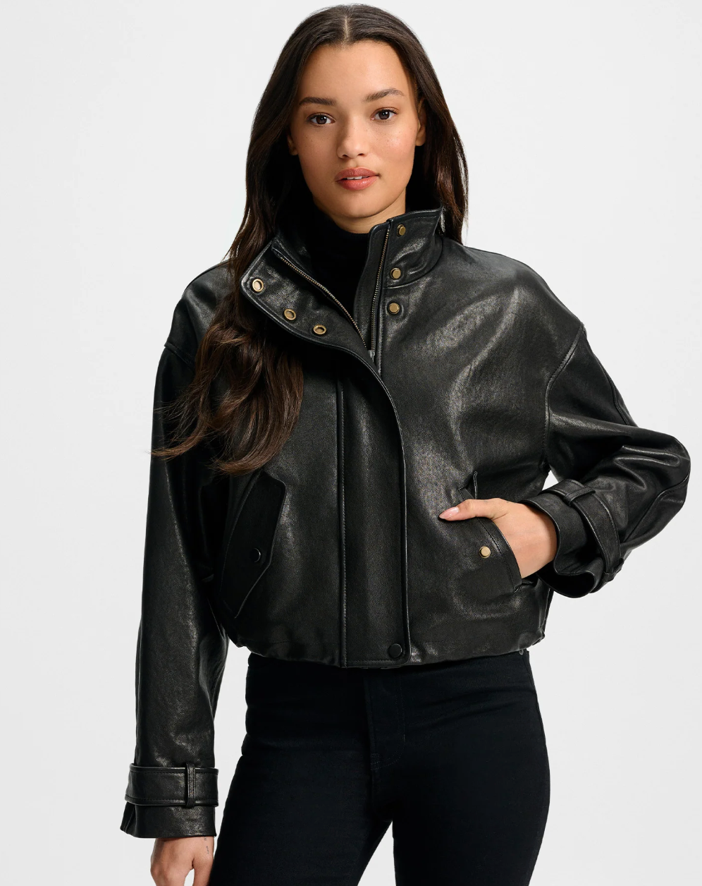 Woman wearing a black leather jacket on a white background