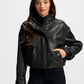 Woman wearing a black leather jacket on a white background