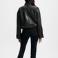 Person wearing a black leather jacket and pants on a white background