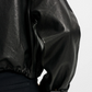 Black leather jacket up close
 with a white background
