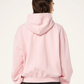 Person wearing a pink hoodie from behind on a white background