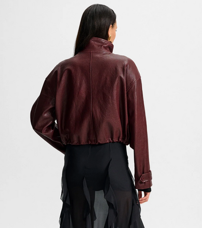 Person wearing a brown leather jacket on a white background