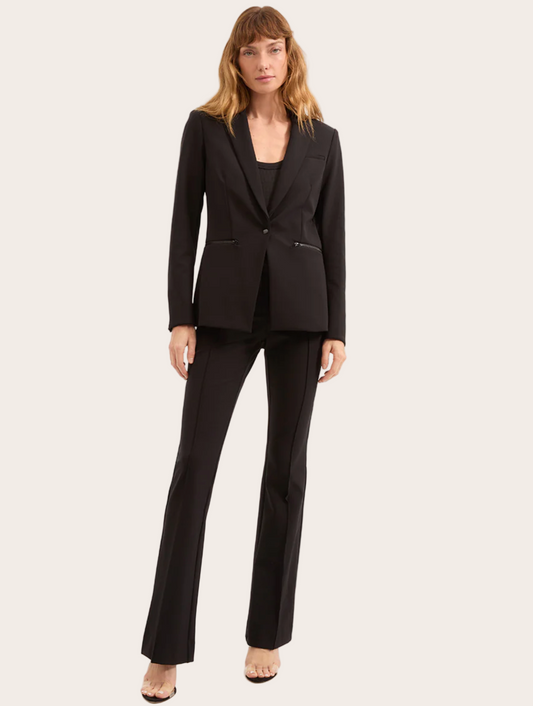 Woman wearing a black suit on a white background