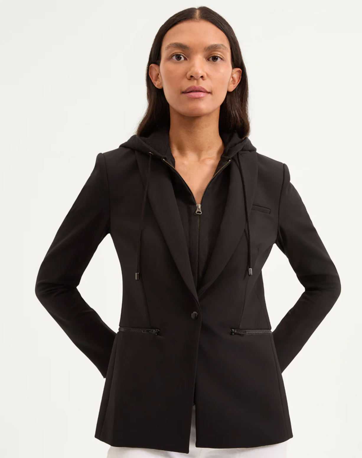 Woman wearing a black blazer with a hood on a white background