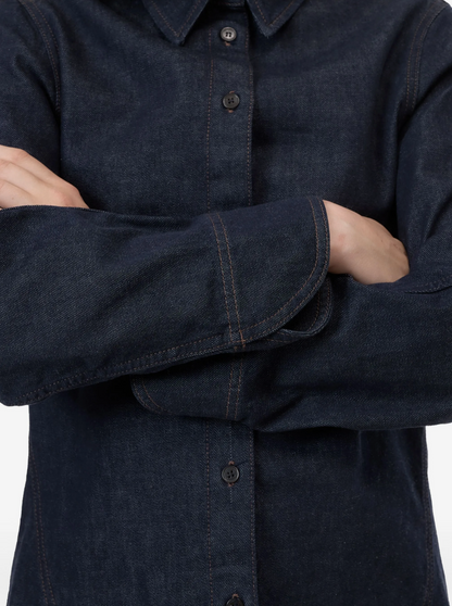 Dark denim shirt with button details on a plain background