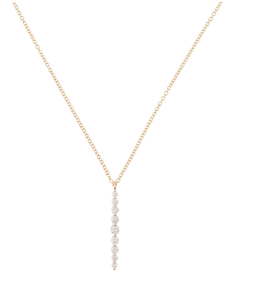 Gold necklace with a small pendant on a white background