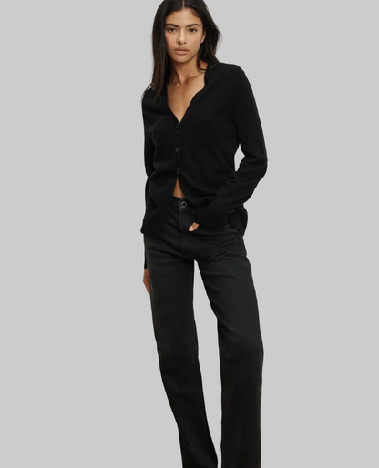 Woman wearing a black cardigan and black pants on a white background
