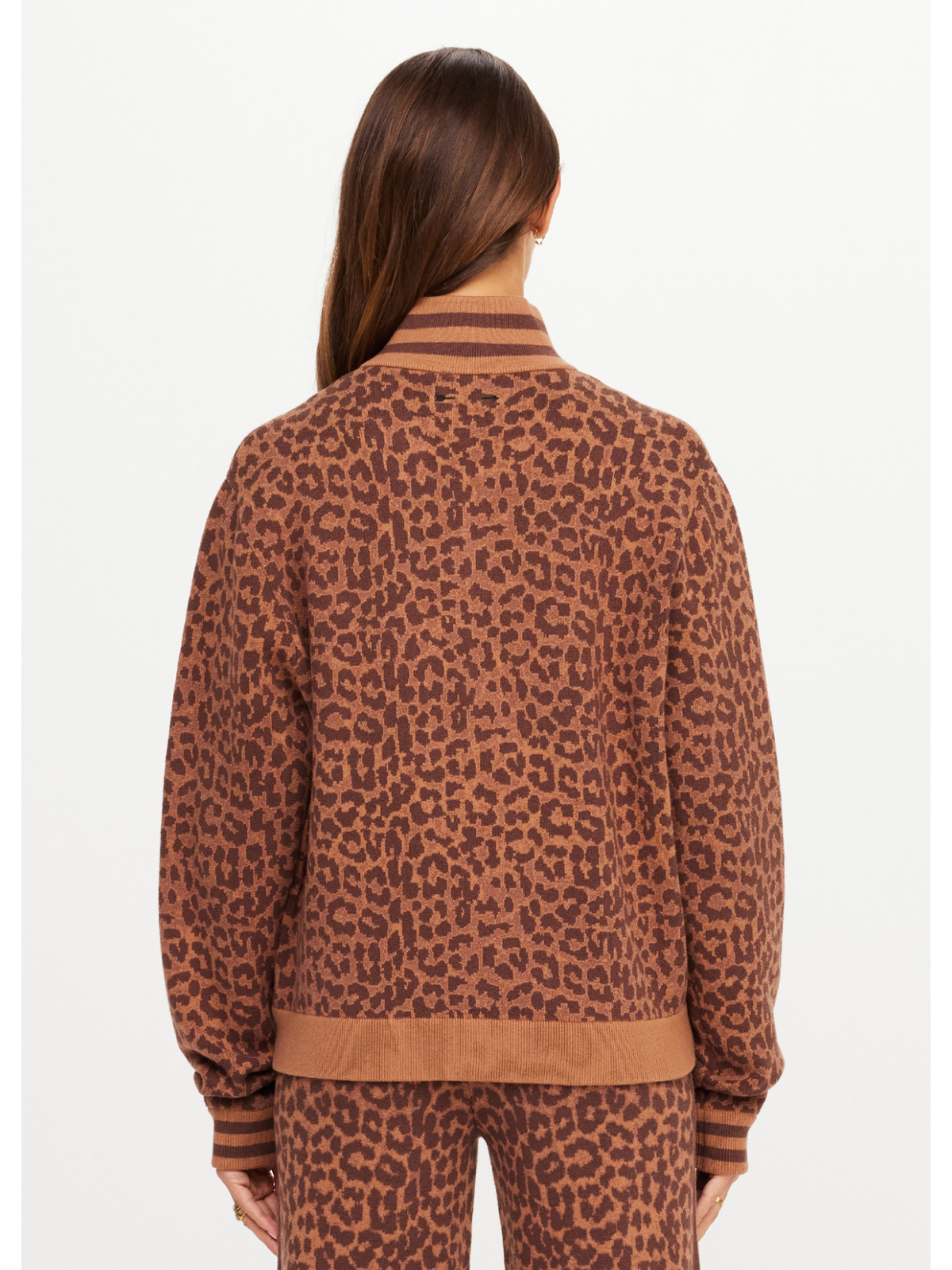Person wearing a brown leopard print outfit on a white background