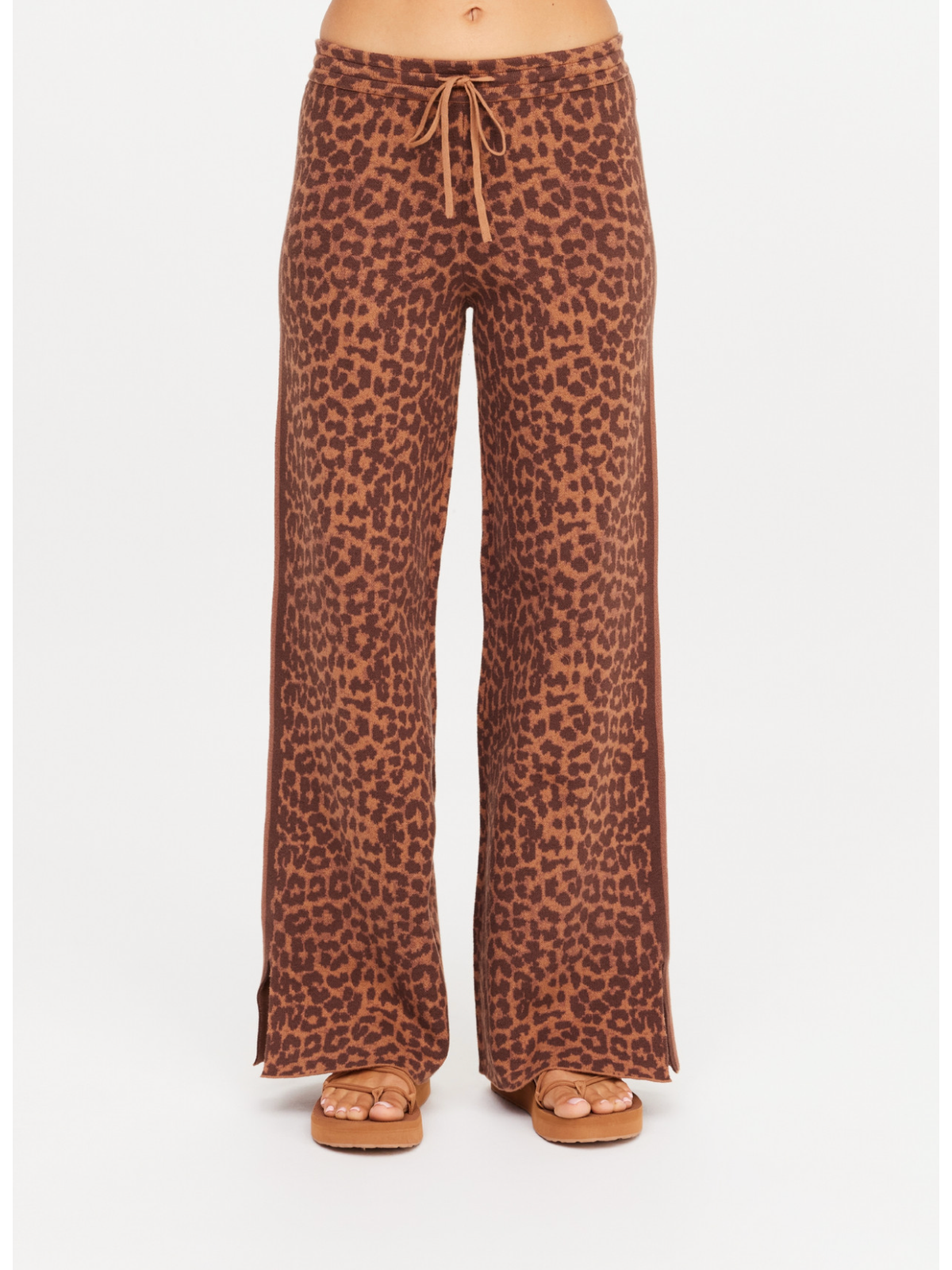 Leopard print pants worn by a person on a white background
