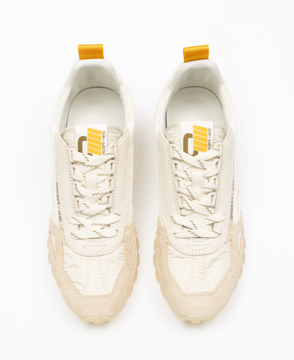 Pair of white sneakers with yellow accents on a white background