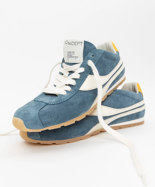 Blue sneakers with white laces and sole on a white background