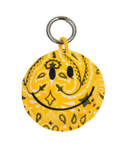 Yellow bandana keychain with smiley face design on a white background