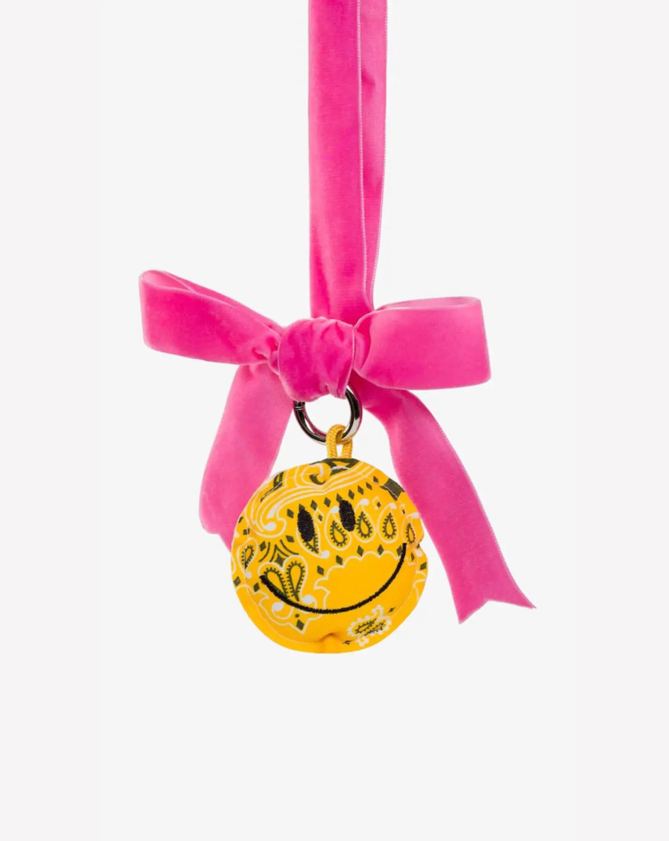 Yellow smiley face charm with pink ribbon on a white background