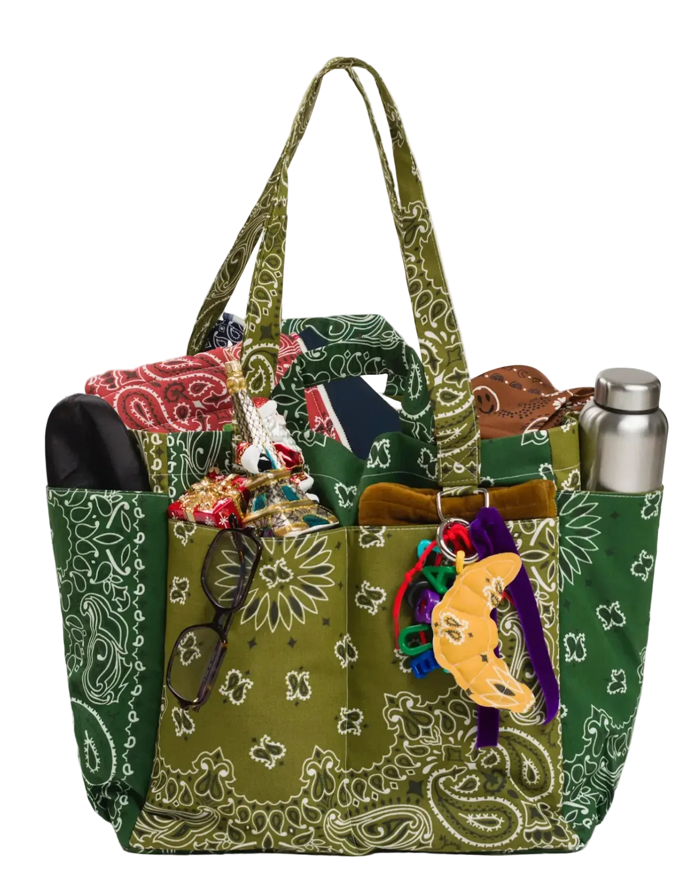 Green patterned handbag with accessories on a white background