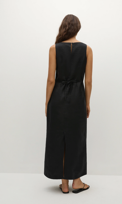 Woman wearing a black sleeveless dress on a white background