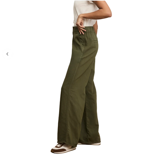 Person wearing olive green wide-leg pants on a plain background