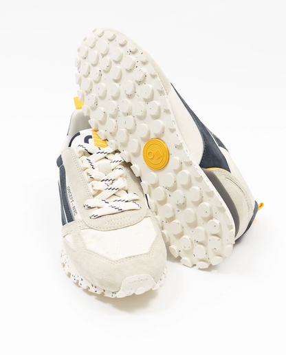 White sneaker with textured sole on a white background