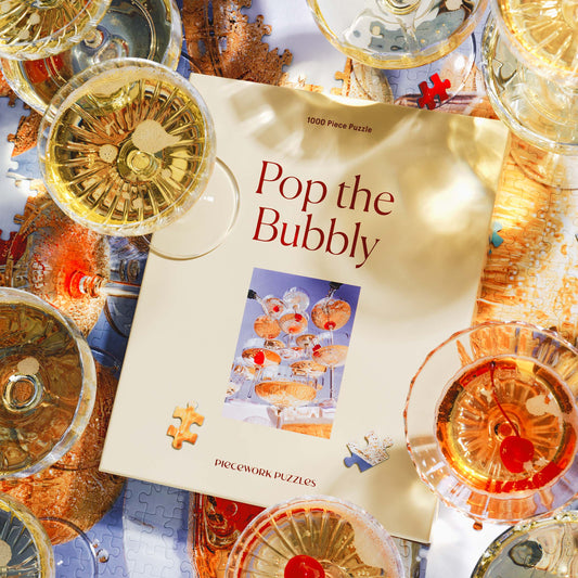 Piece Work Puzzles Pop the Bubbly 1000 piece jigsaw puzzle available at Hiptique Woodland Hills California