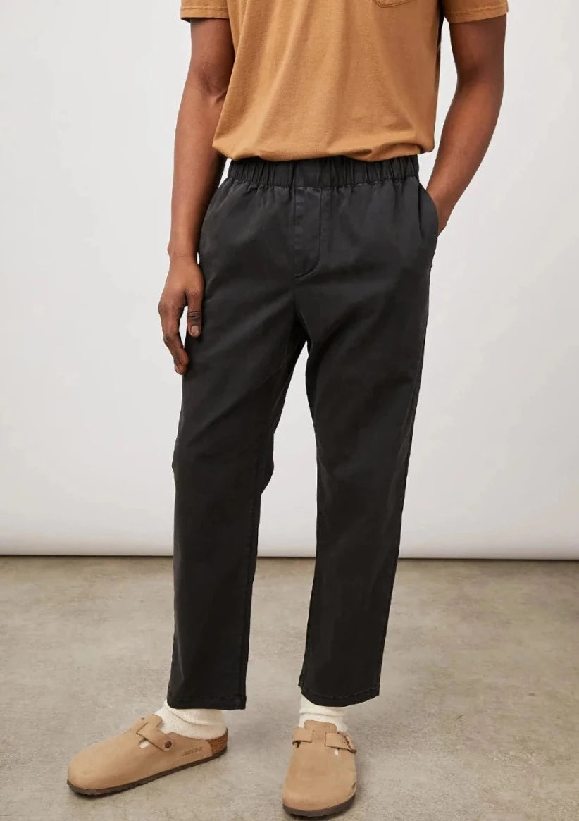 these comfortable pants are half way in between a relaxed and slim fit with an elastic waistband  52% Cotton | 46% Modal | 2% Spandex.  fits true to size