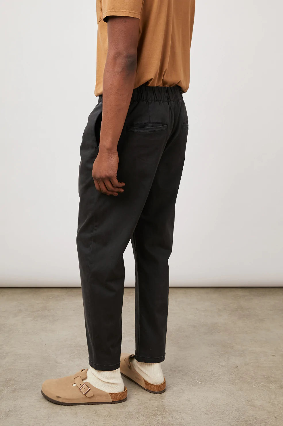 these comfortable pants are half way in between a relaxed and slim fit with an elastic waistband  52% Cotton | 46% Modal | 2% Spandex.  fits true to size