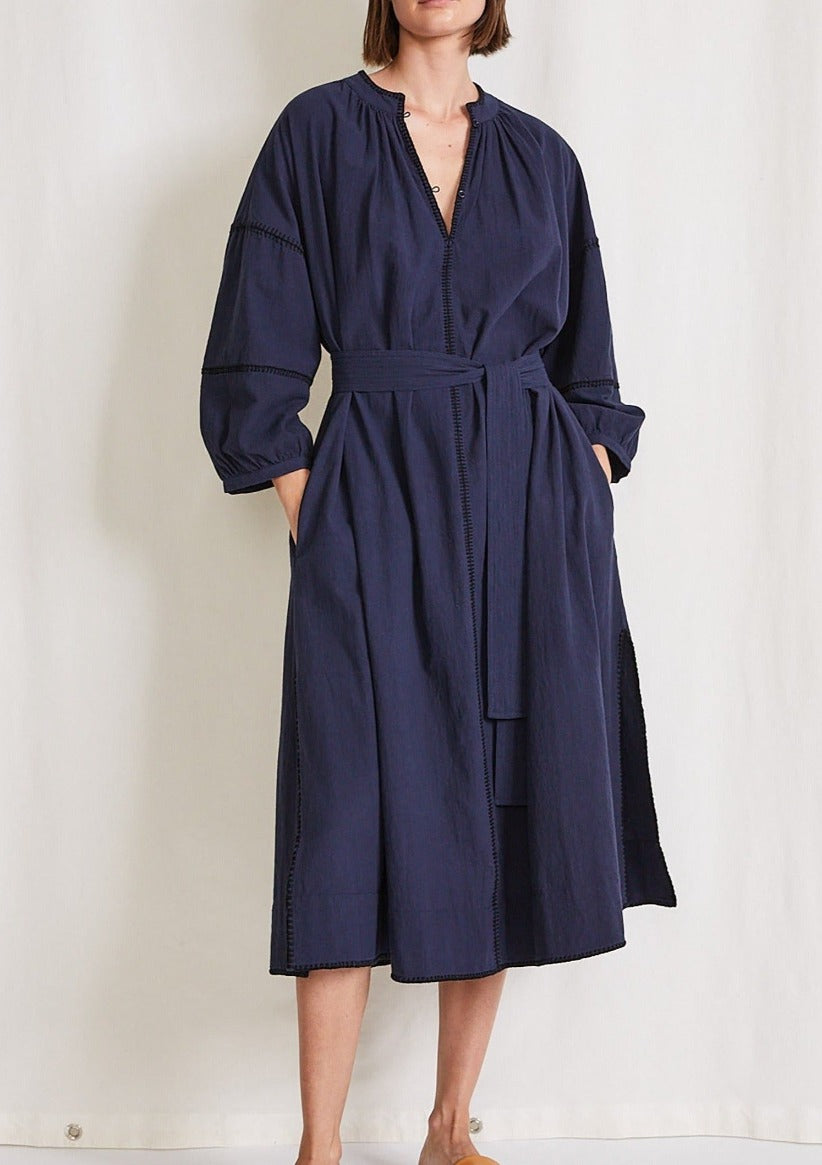 ALMUDAINA DRESS NAVY COTTON DRESSA gorgeous navy blue dress with long sleeves, mid length, fabric belts. The most beautiful edge detail, handmade in India. Sophisticated and casual this is the most wearable dress in the finest material we have in stock, you wont be disappointed.