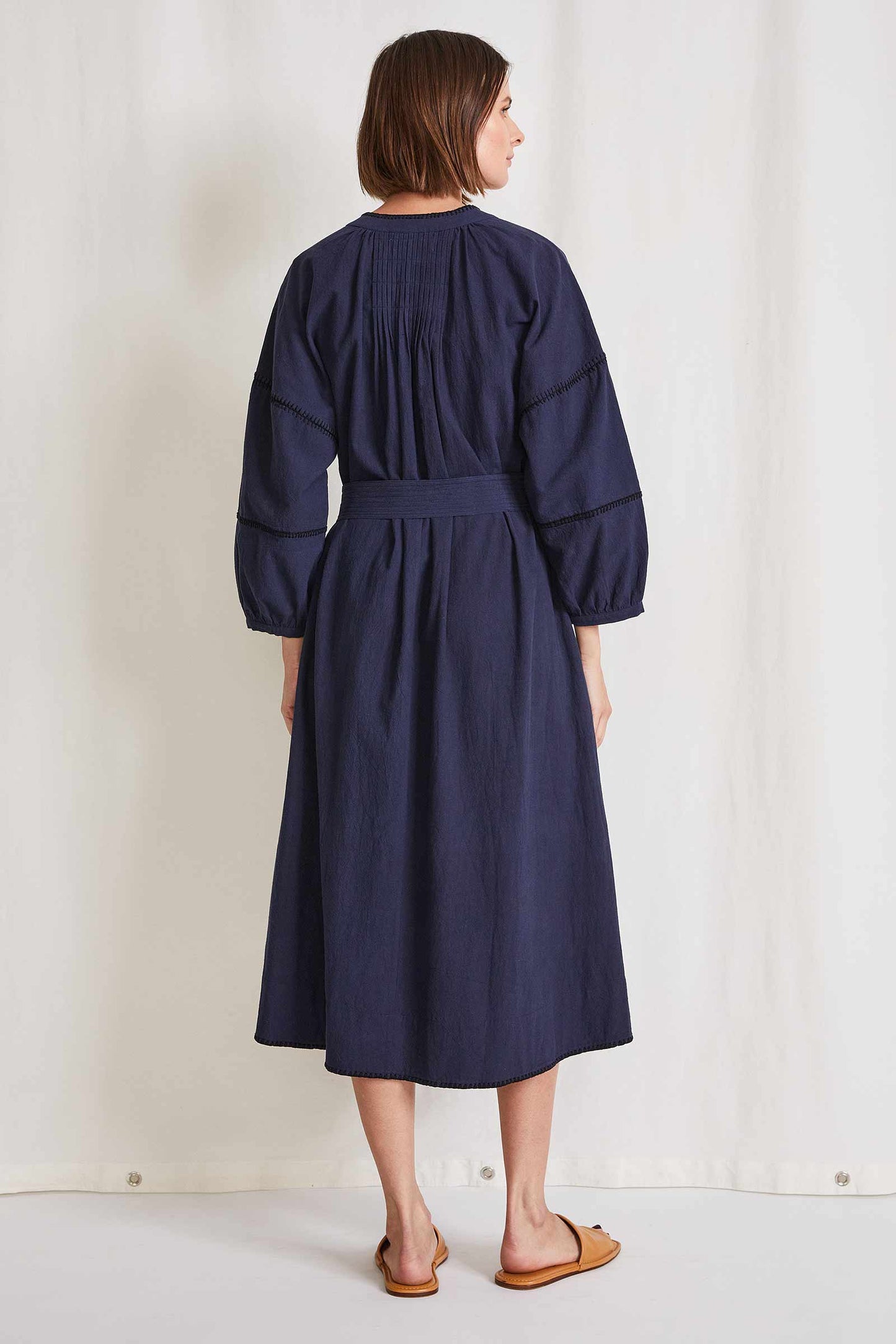 A gorgeous navy blue dress with long sleeves, mid length, fabric belts. The most beautiful edge detail, handmade in India. Sophisticated and casual this is the most wearable dress in the finest material we have in stock, you wont be disappointed.